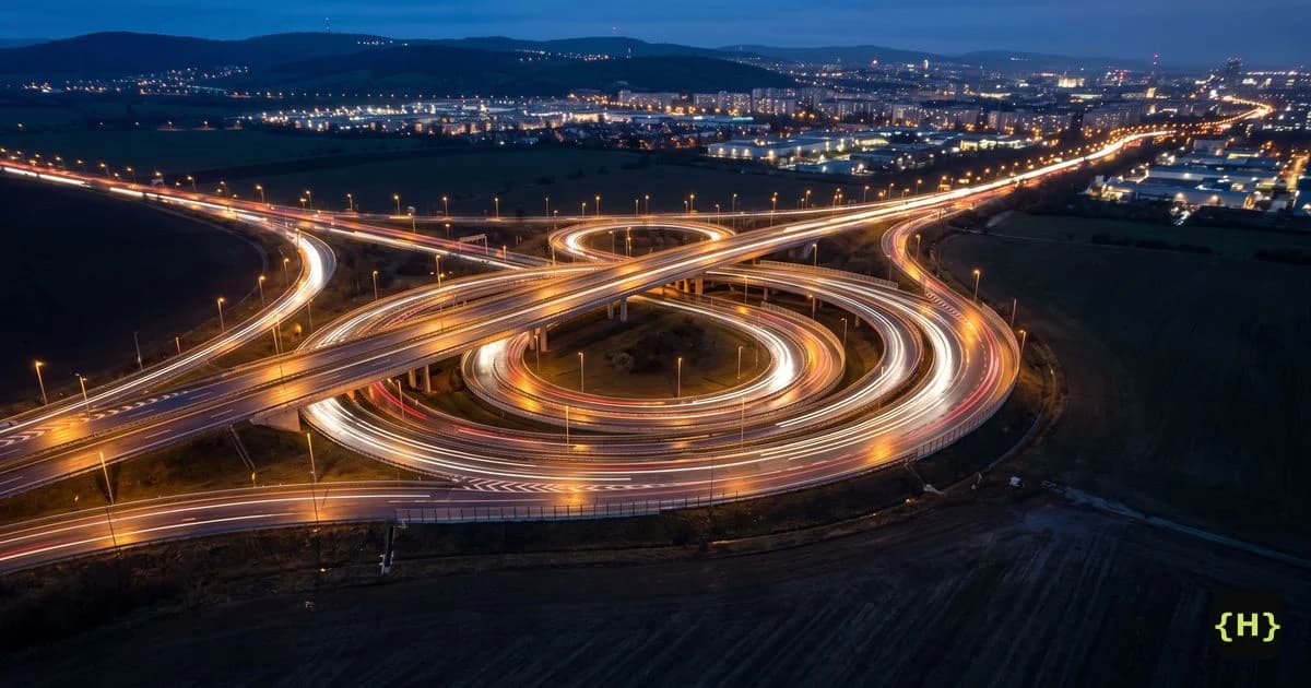 A highway interchange at night with ramps looping back on themselves, illustrating a WordPress too many redirects loop